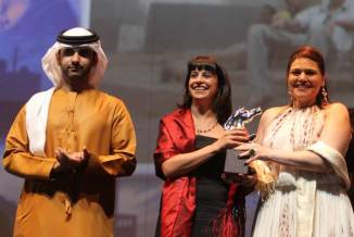 Director Nadine Khan (centre) and producer Dina Farouk receive the Special Jury Prize for 'Chaos, Disorder' (2012) at the 9th Dubai International Film Festival